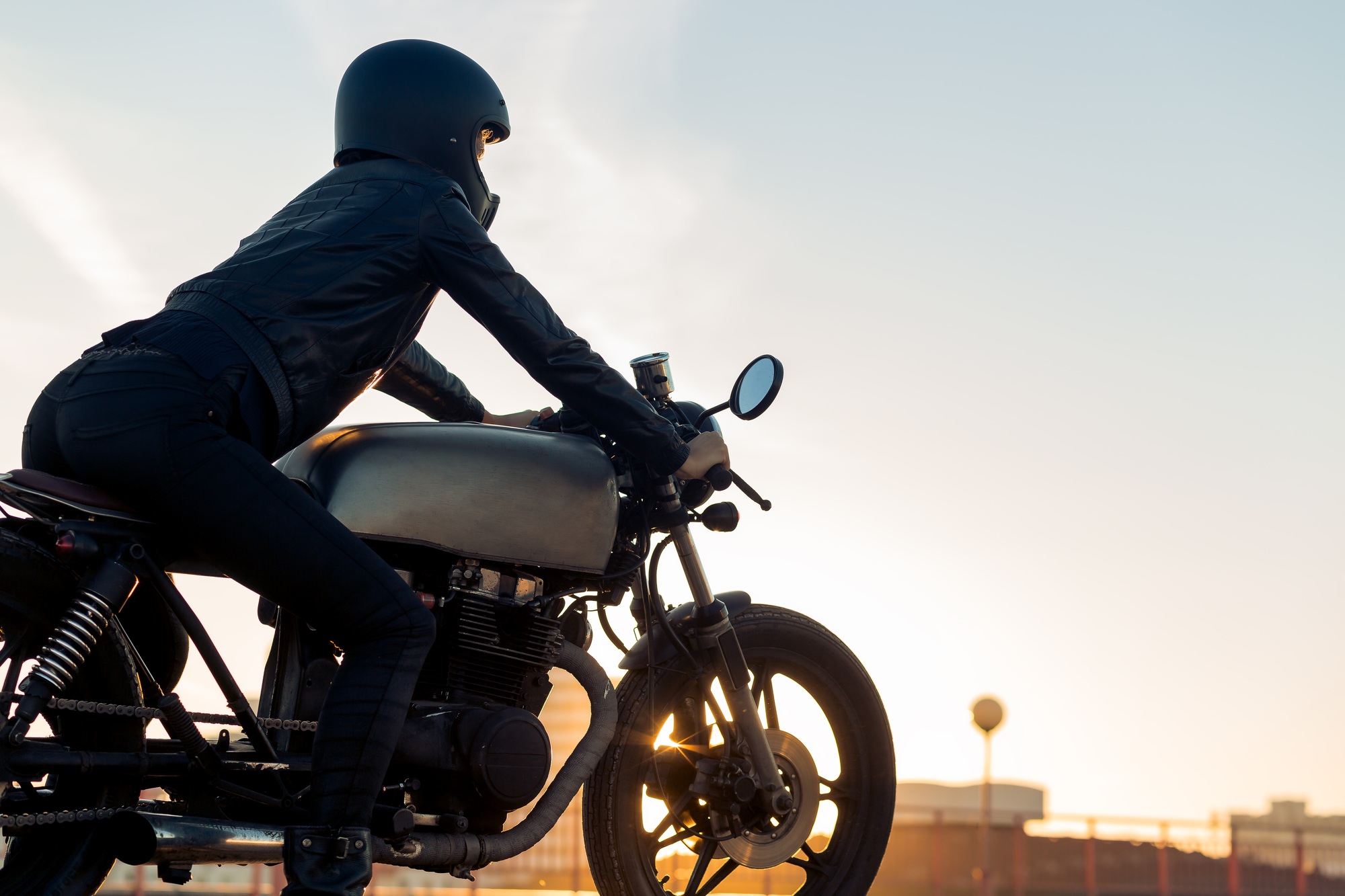 Biker girl on caferacer motorcycle.